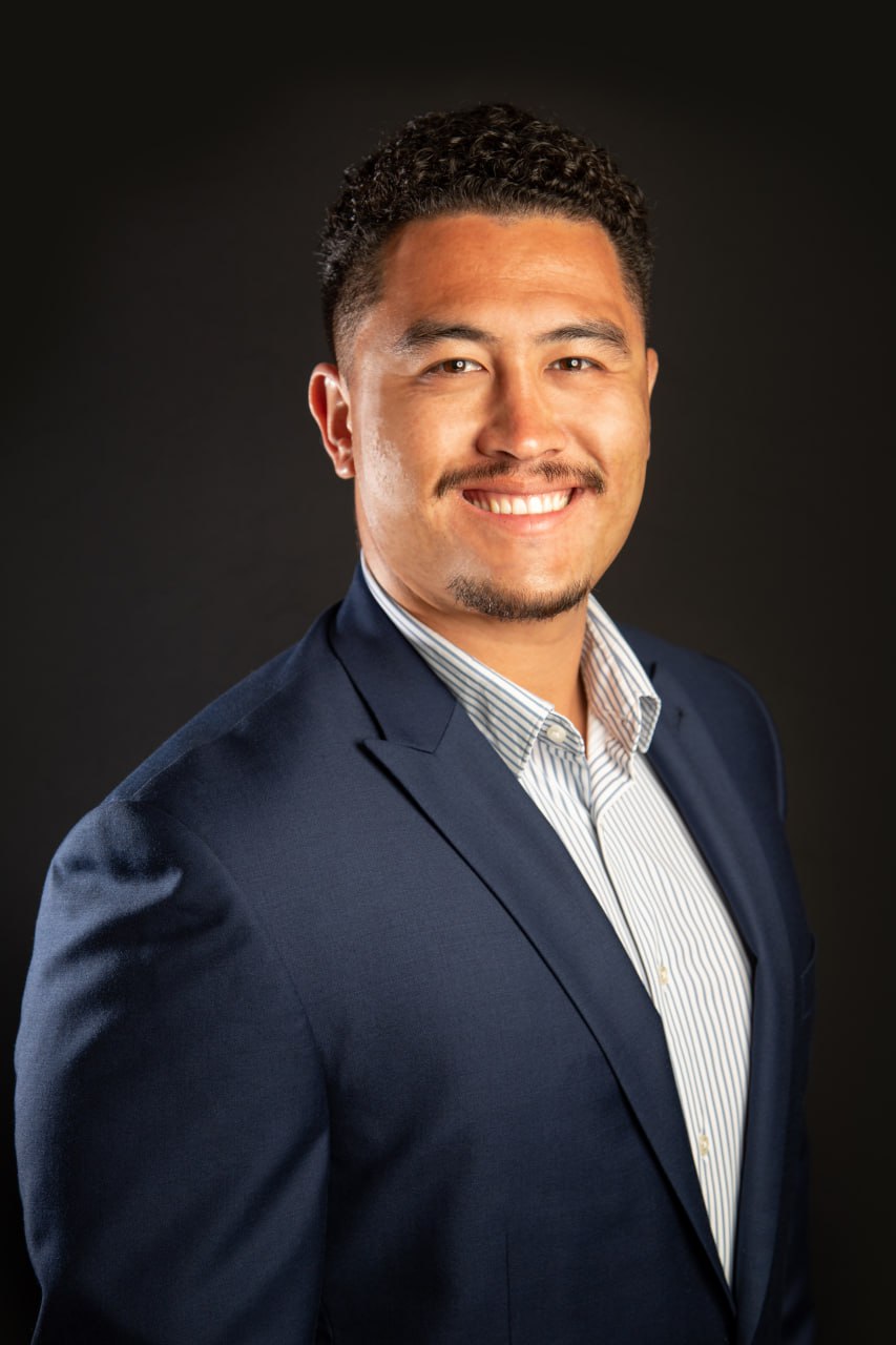 Rusty Rau, San Diego Real Estate Agent smiling in professional attire